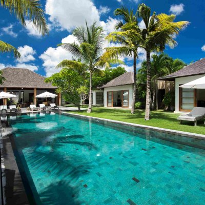 Villa Tiga Puluh, a modern tropical villa featuring a private pool, open-air living spaces, lush gardens, and Balinese-inspired architecture for a relaxing stay.