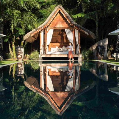 Villa Tiga Puluh, a modern tropical villa featuring a private pool, open-air living spaces, lush gardens, and Balinese-inspired architecture for a relaxing stay.