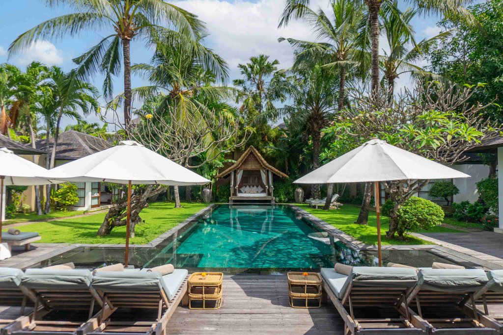 Villa Tiga Puluh, a modern tropical villa featuring a private pool, open-air living spaces, lush gardens, and Balinese-inspired architecture for a relaxing stay.