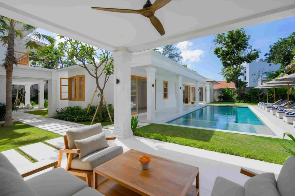 Amenara kanan_Pool from the Main Building – Showing the far-end room + View from right side of outdoor living room through sliding doors towards sunken living room_11zon Bali Villas